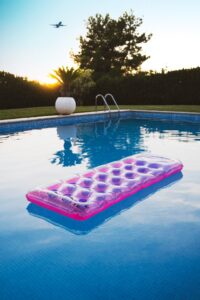 Picture of pink pool float in middle of pool.